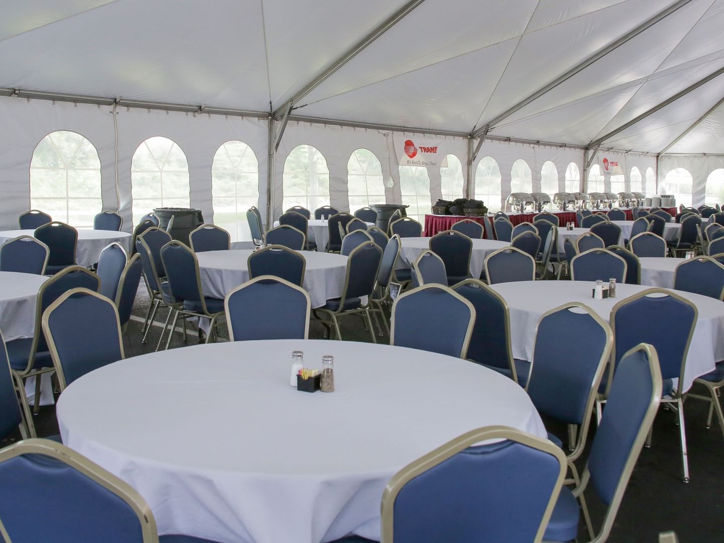 Banquet tables arranged in an Outdoor tent at Music Road Resort