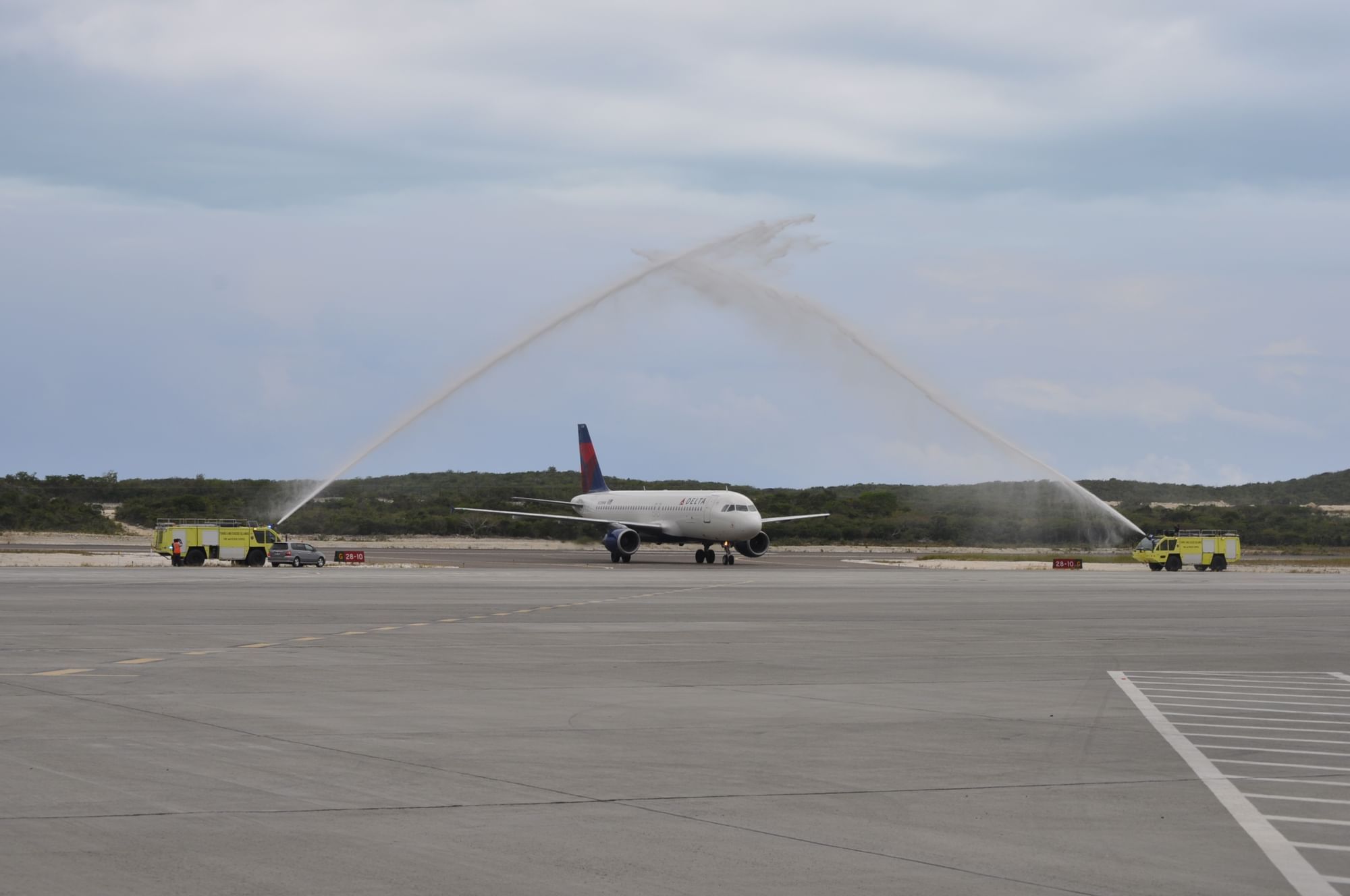 Airplane landing at the airport near The Somerset on Grace Bay