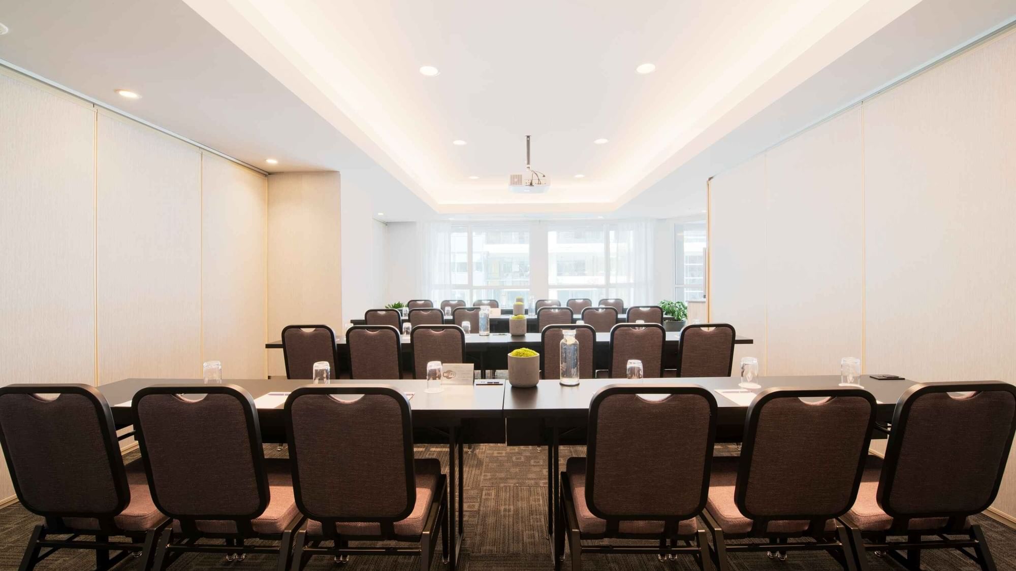 Large conference room at Warwick Hotels and Resorts, set up classroom-style with rows of tables and chairs