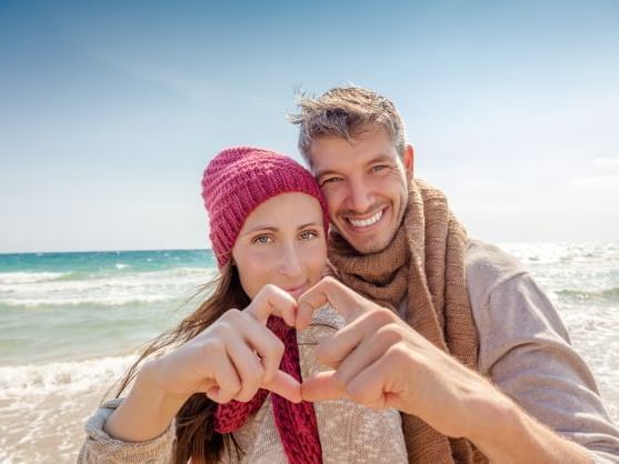 A couple with loving faces at the beach near Ana Hotels
