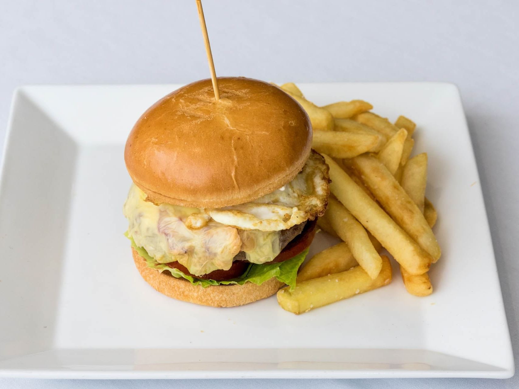 Beef Burger served with a side of fries at Hotel Grand Chancellor Townsville