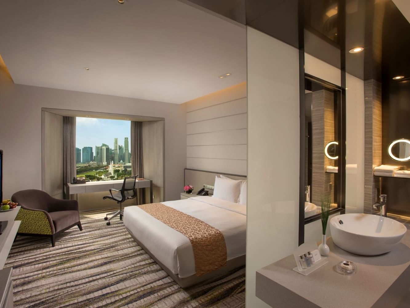 Bed with city view in Deluxe Room at Carlton Hotel Singapore
