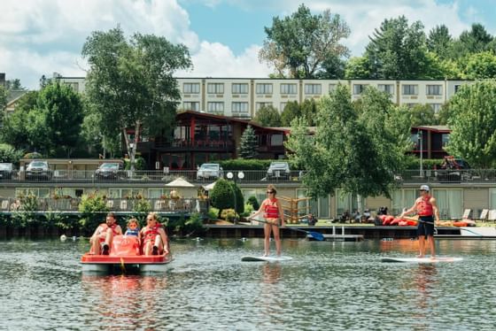 People engaging in recreation at the lake at High Peaks Resort