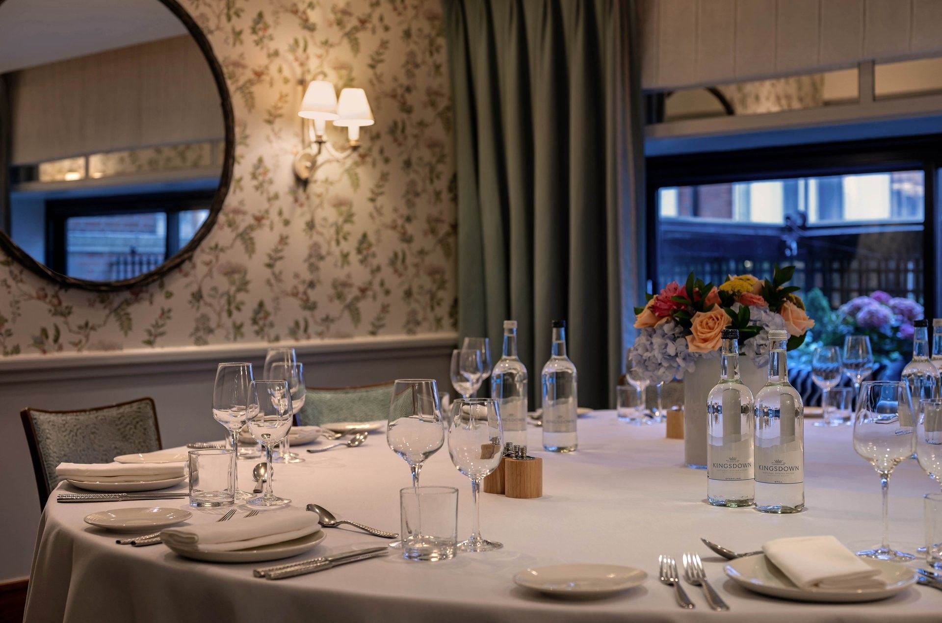 Set up a dining table near the hanging mirror in The Eaton at The Capital Hotel, Apartments and Townhouse