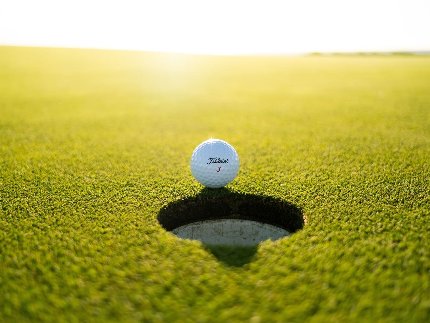 a golf ball next to a hole