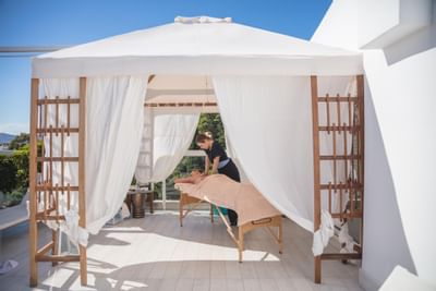 Woman enjoying a poolside massage at St. George Lycabettus