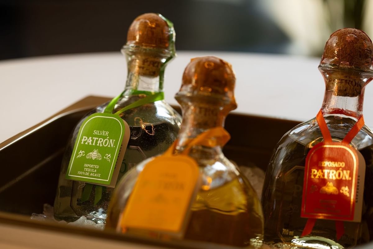 Close-up of 3 tequila bottles in a box in May Fair Bar at The May Fair Hotel