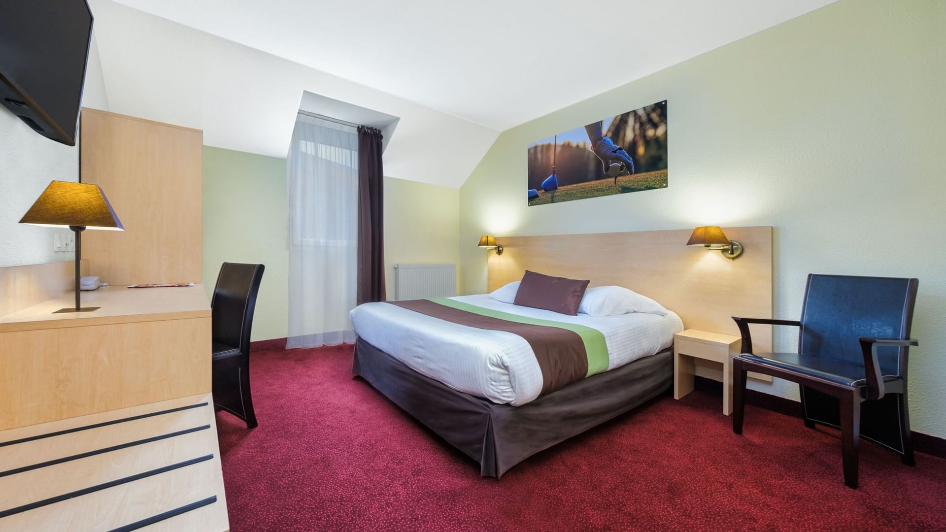 Bed arrangement in Hotel Acadine of The Originals Hotels