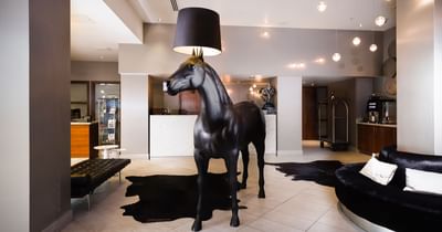 The lobby area at the Sandman Signature Newcastle Hotel with bla