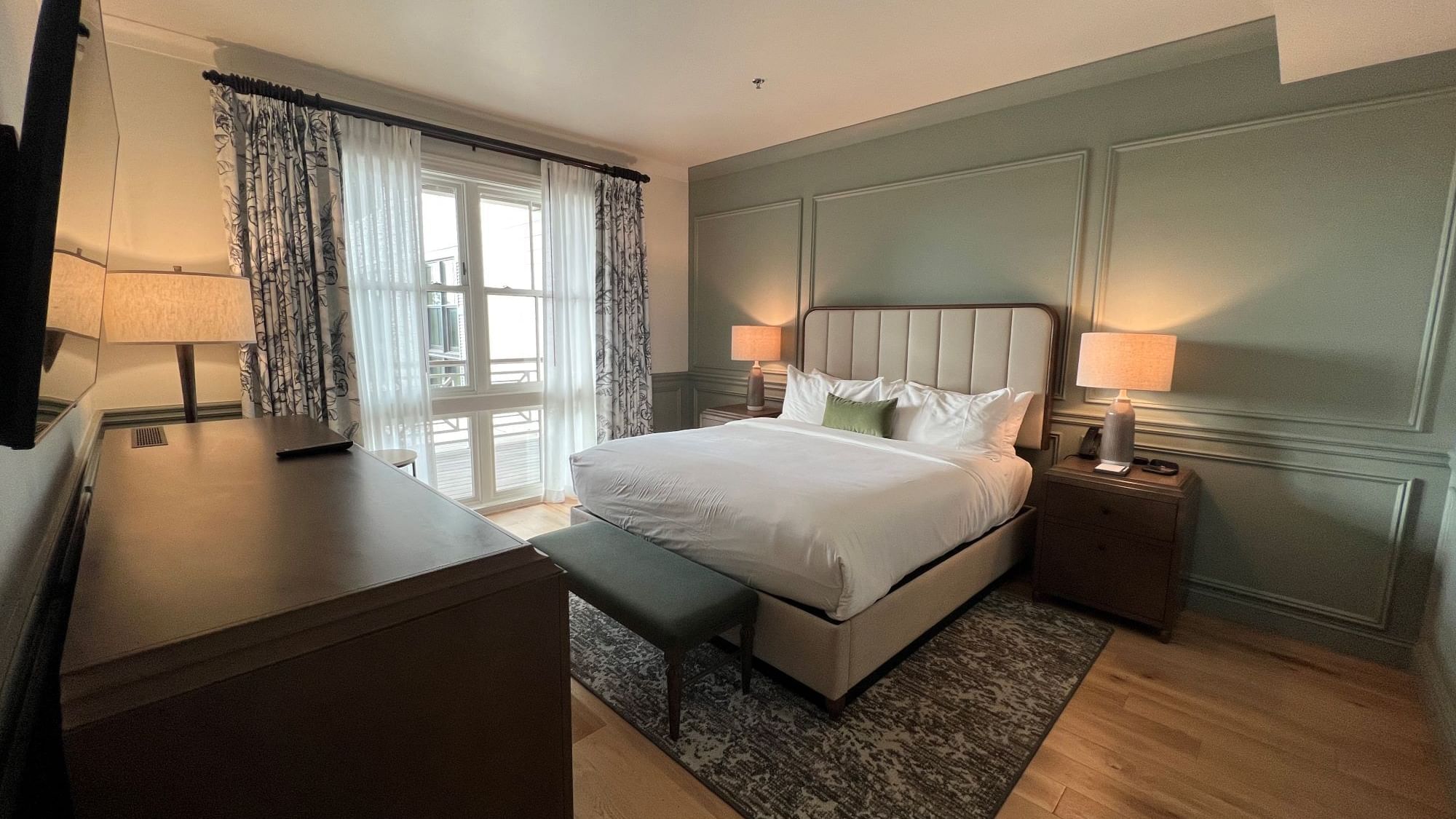Drawer & TV facing the king bed in Pine Suite with wooden floors at Camp Creek Inn