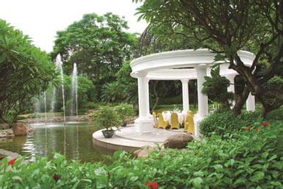 Serene gazebo nestled in a vibrant garden at Hanoi Daewoo Hotel