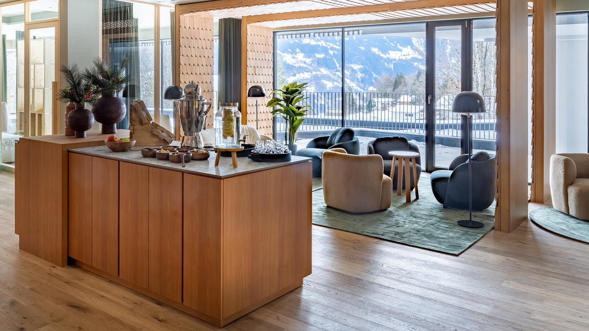 Acquapura Organic SPA with stylish furniture, large windows and a mountain view at Falkensteiner Hotel Montafon