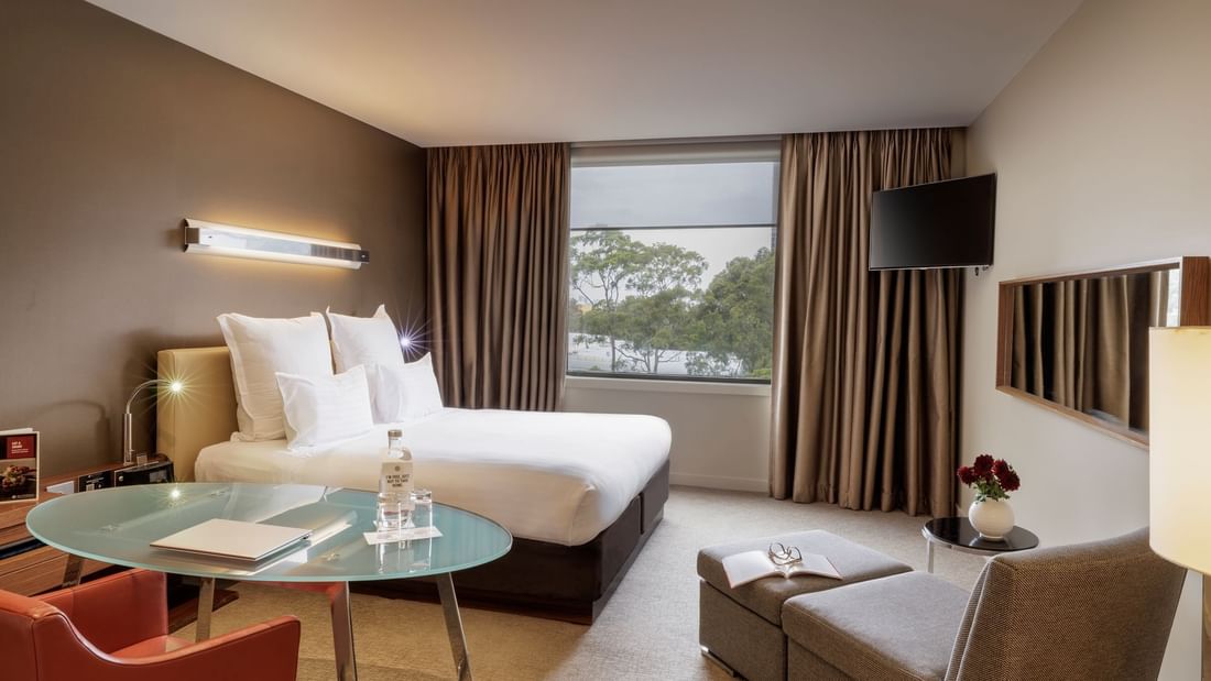 Workdesk with bed by the windows in Pullman Superior King Room at Pullman Sydney Olympic Park