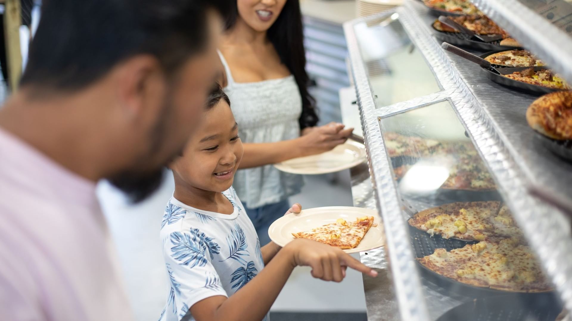 Family selecting dining options by the counter in Bruno’s Pizza at Watersound Inn