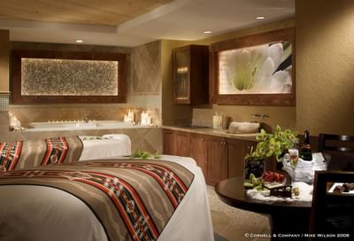 Beautiful Wo'P'in Spa treatment room at Hilton Santa Fe Buffalo Thunder with two massage tables and a whirlpool tub