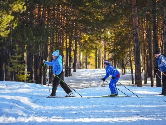 Three kids snow skiing near The Lake House