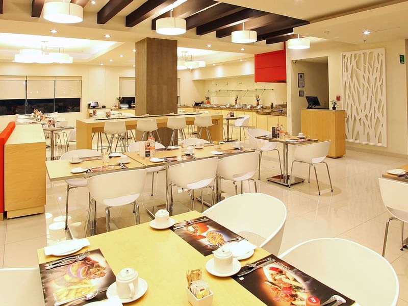 Arranged tables & chairs in a restaurant at Fiesta Inn Hotels