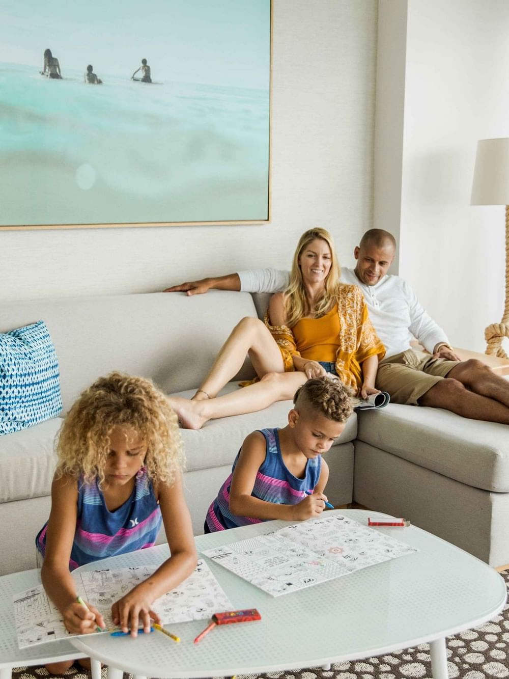 Family lounging on couch in 2-bedroom family suite