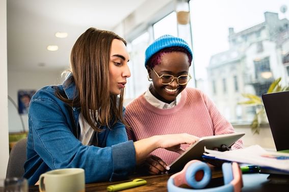 Two female employees are discussing a topic