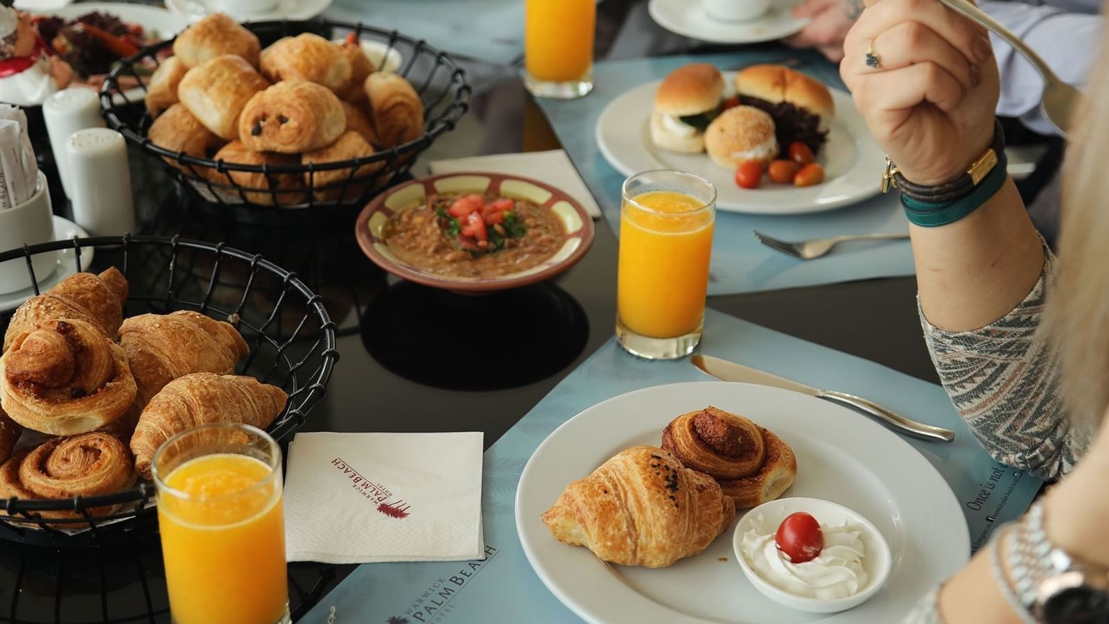 Croissants and Juices served on a table for breakfast in Palm Room at Warwick Palm Beach Hotel