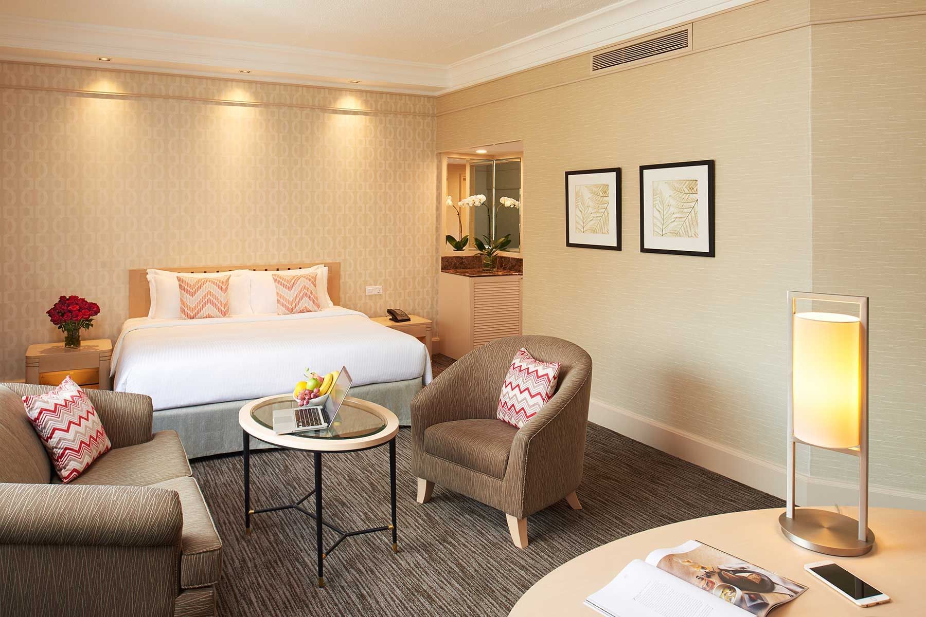 Image 38: Seating area by the bed in Deluxe Room with carpeted floors at York Hotel Singapore