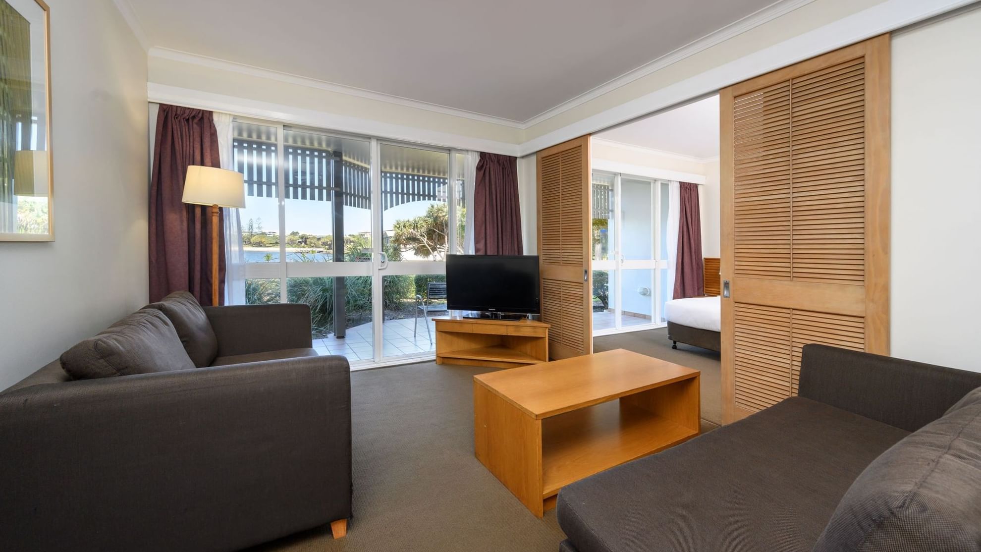 Novotel Sunshine Coast Resort One Bedroom Suite living room with lagoon view