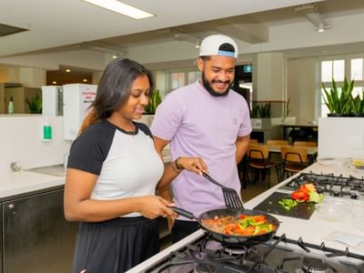 Students cooking together in the kitchen at UniLodge Herston.