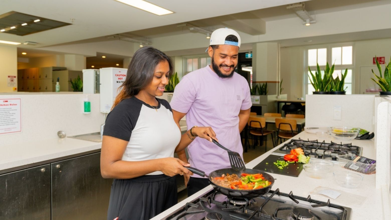 Students cooking together in the kitchen at UniLodge Herston.