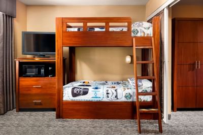 TV stand by the bunk bed in Galaxy Suite at Anaheim Portofino Inn, where to stay near Disneyland with separate kids room