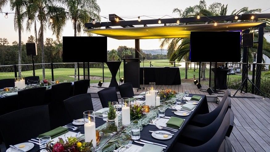Elegant outdoor dining setup on Sunset Deck at Mercure Gold Coast Resort in Carrara.