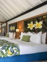 Twin bed facing table & chair with plumeria floral artwork in Garden Bungalow at warwick le lagon-vanuatu