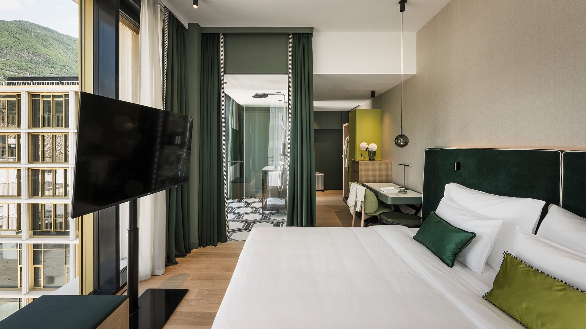 Elegant Grand Deluxe Corner room with mountain view at Falkensteiner Hotel Bozen WaltherPark in Bolzano.