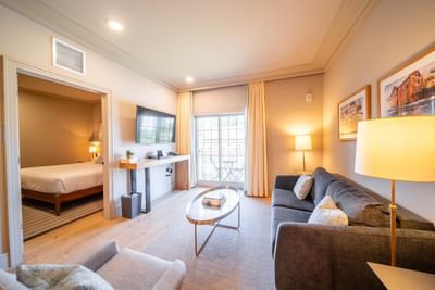 Cozy bed & TV lobby area in King Suite at Hotel Weyanoke