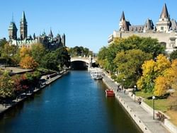 Rideau Canal view in Ottawa, framed by vibrant autumn foliage and historic buildings near ReStays Ottawa