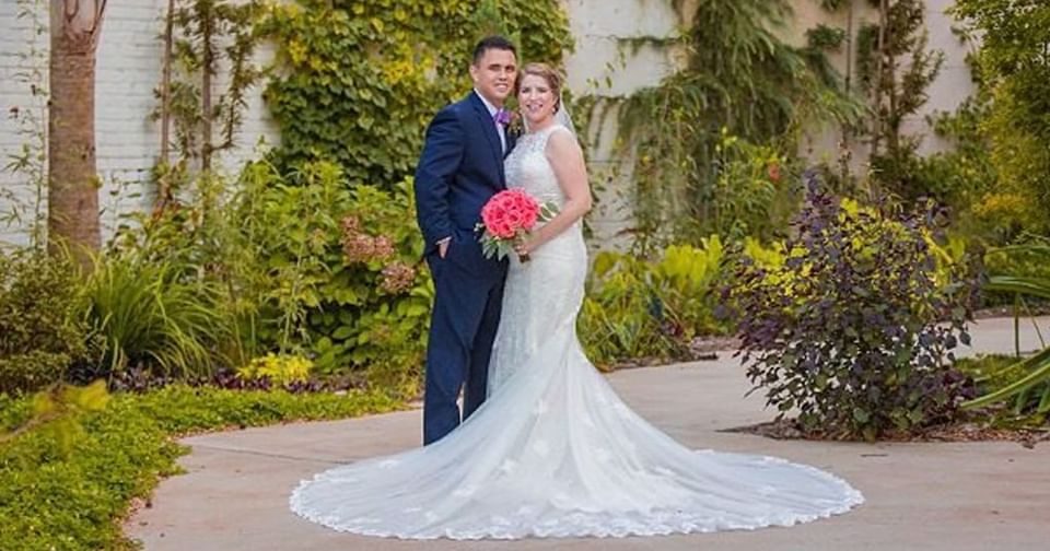 Wedded couple posing by a green lawn in Inn at the Crossroads