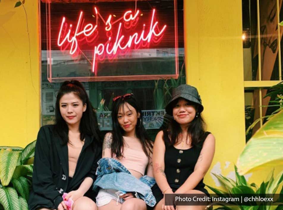 Three ladies were taking a picture together outside the PIK NIK cafe - Lexis Suites Penang