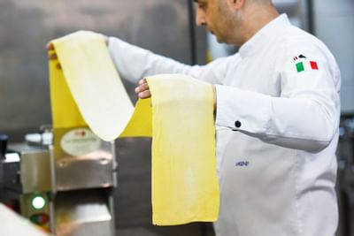 italian chef preparing pasta at Al Aziziyah Boutique Hotel Doha
