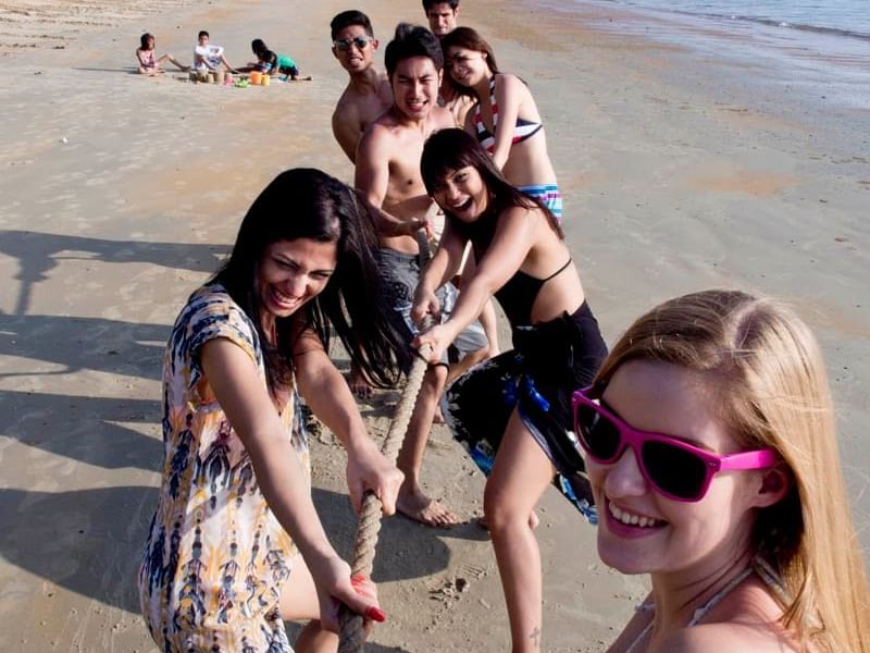 A group of people playing tug of war