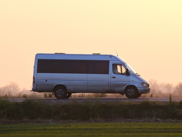 Free shuttle service van on a street near Midnight Sun, a Coast Hotel