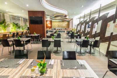 The arranged dining area with tables and chairs