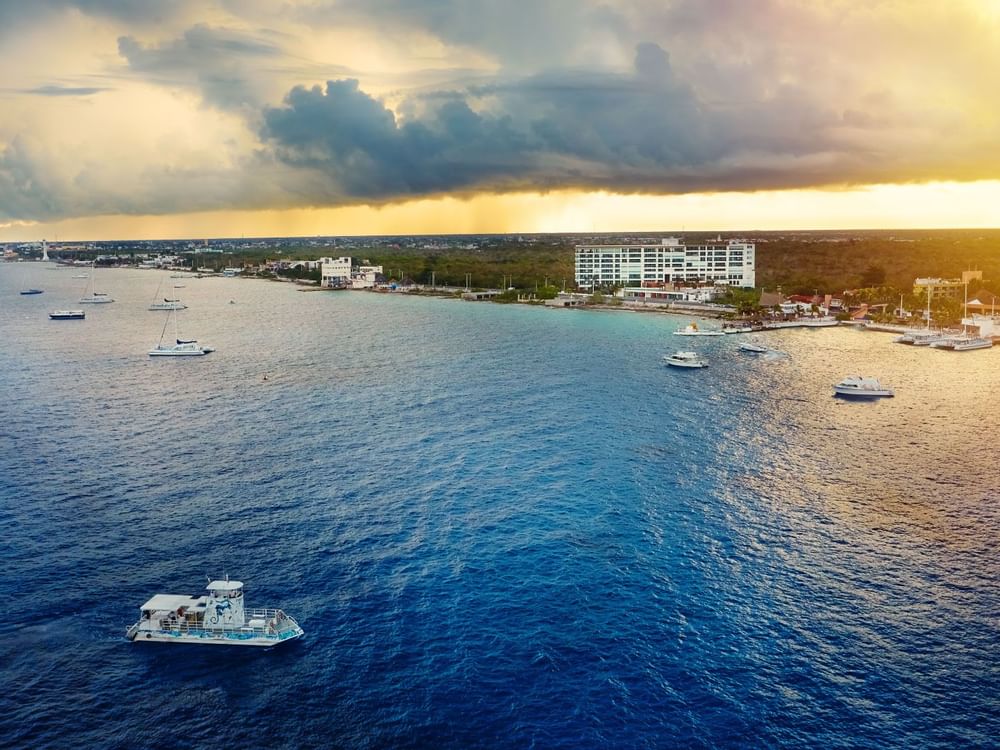 A sea with yachts along with the beach in the Cozumel