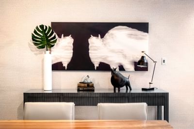 Stylish console table displaying a bull sculpture with a leaf vase and an abstract painting at The Riverwalk Plaza Hotel