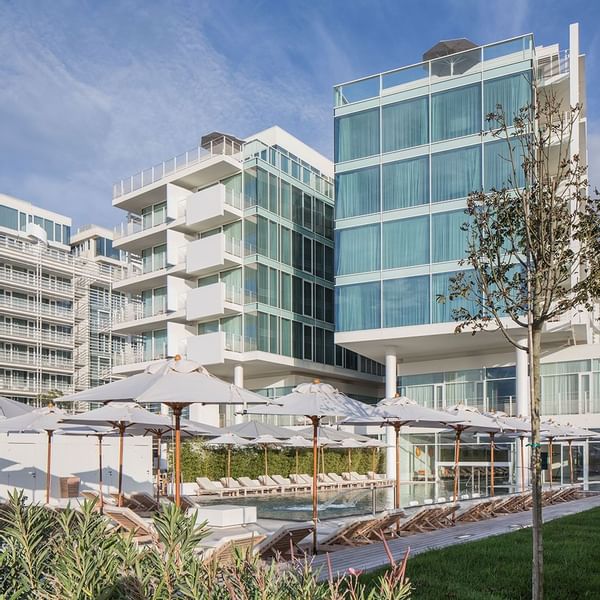 Low-angle view of Falkensteiner Hotel & Spa Jesolo with outdoor pool area with loungers