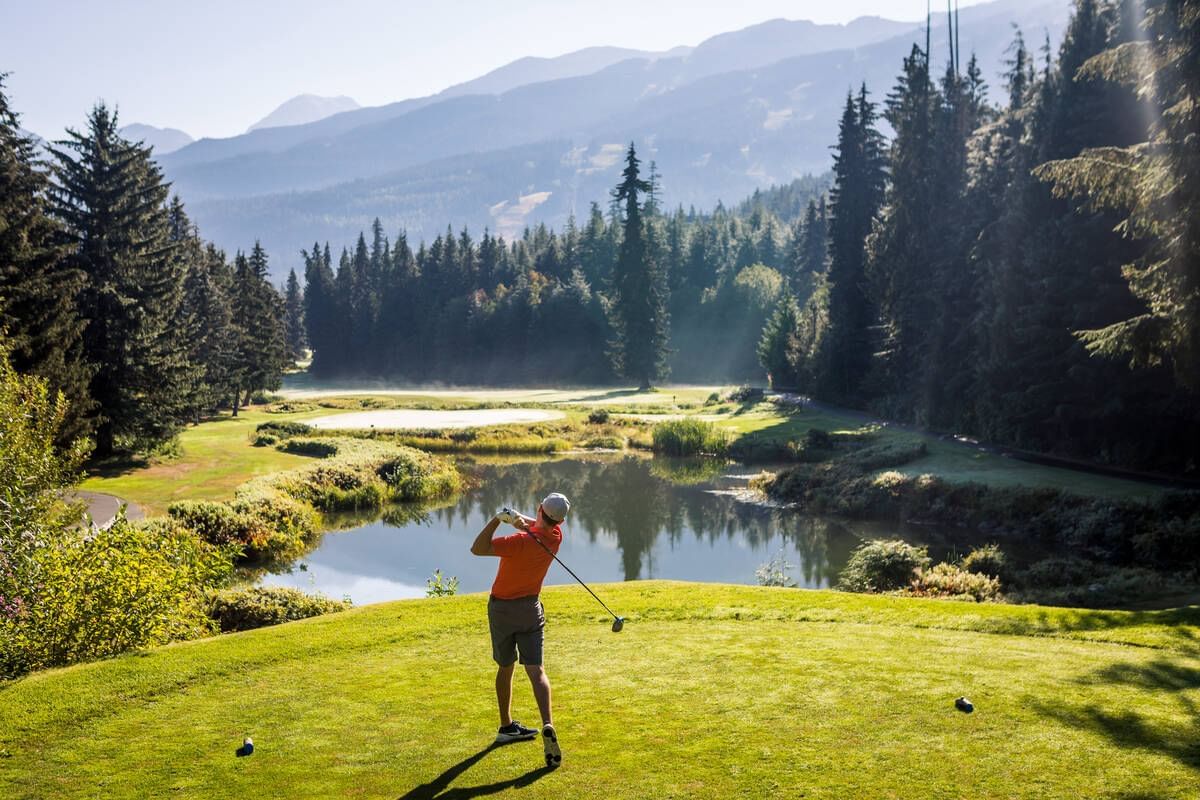 Man playing golf in Fairmont Chateau Whistler Golf Club near Blackcomb Springs Suites