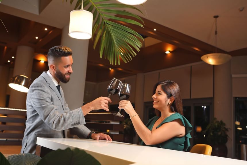 couple cheersing wine glasses in restaurant