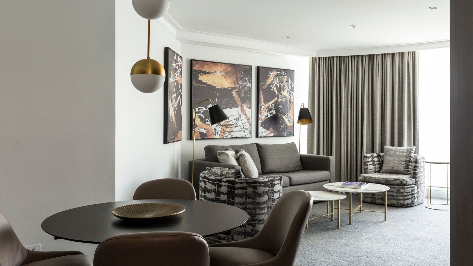 Dining table, sofa & lamps at Pullman Quay Grand Sydney