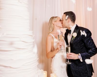 Newly wedded couple kissing at Luxe Sunset Boulevard