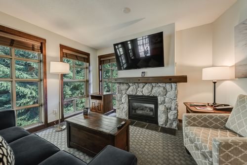 Fireplace by TV lounge area in 2 Bedroom Suite at Blackcomb Springs Suites