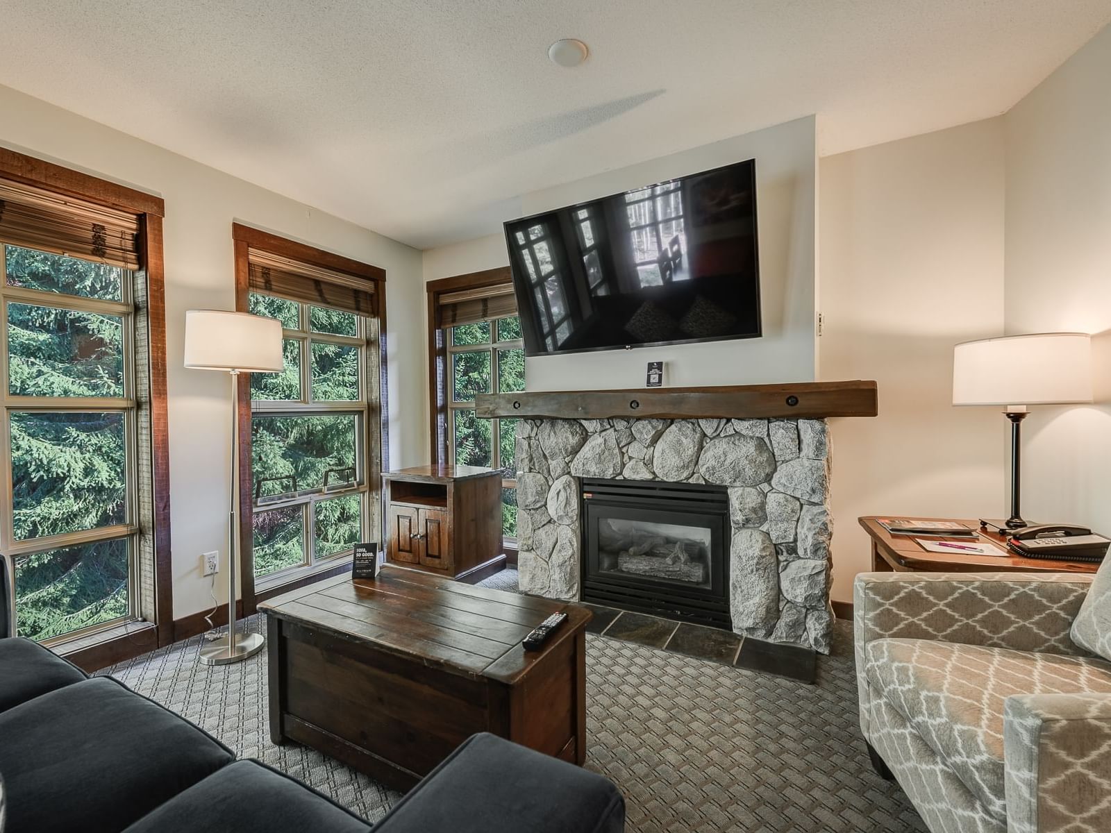 Fireplace by TV lounge area in 2 Bedroom Suite at Blackcomb Springs Suites