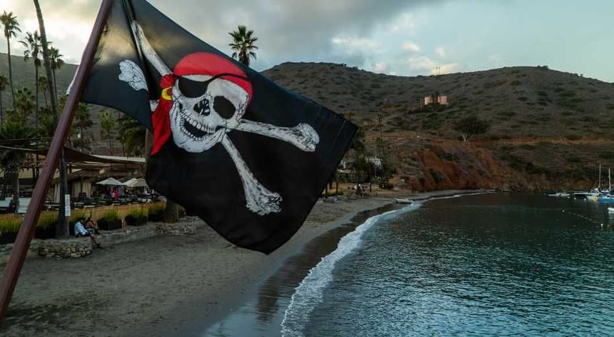 Pirate flag waving on sandy beach for a Halloween party near Catalina Island Company